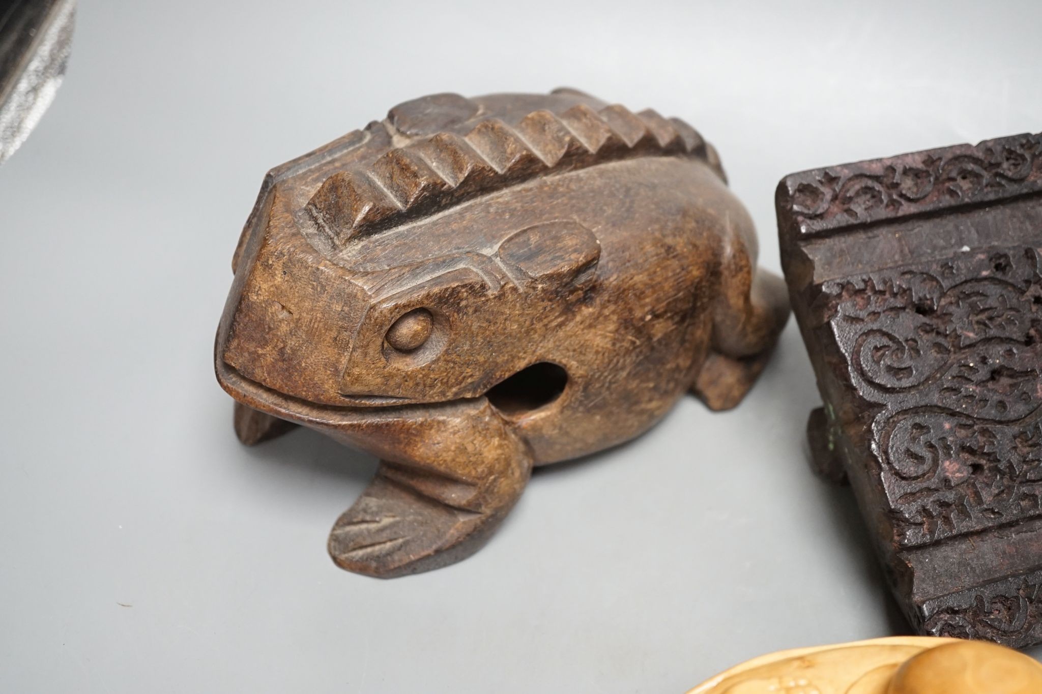 A Chinese carved wood frog, 22cm long, a carved Buddha, woodblock and a part-set of draughtsmen